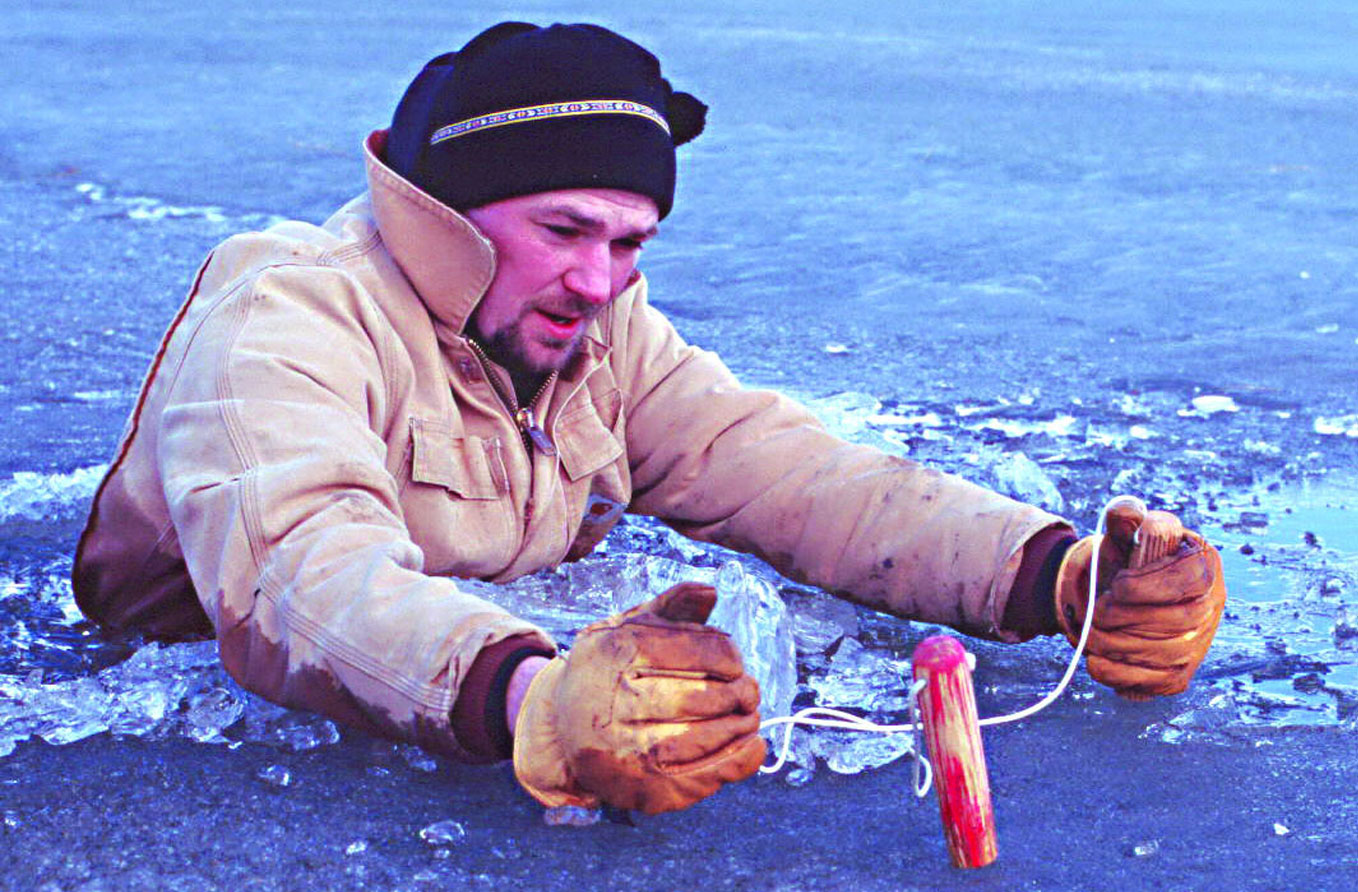 Person using ice picks to get out of water